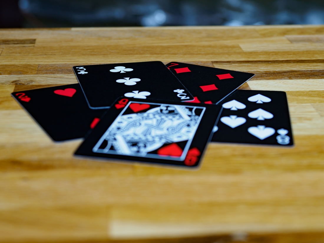 black and white playing cards on brown wooden table