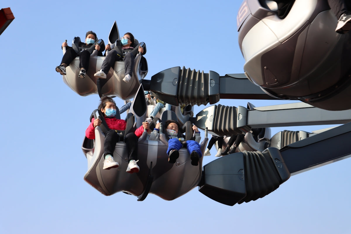 a group of people riding on top of a roller coaster