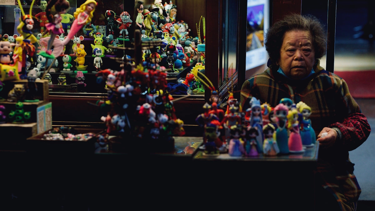 a man standing in front of a display of toy figures