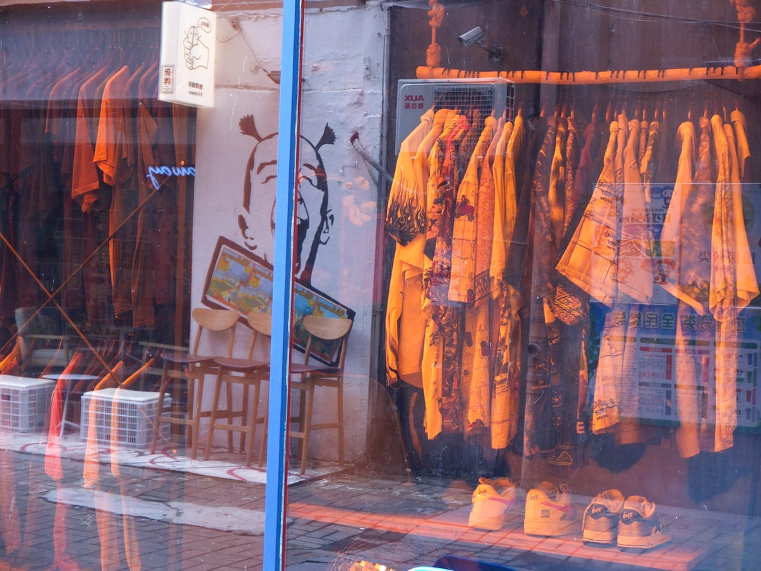 a room with a table and a bunch of clothes