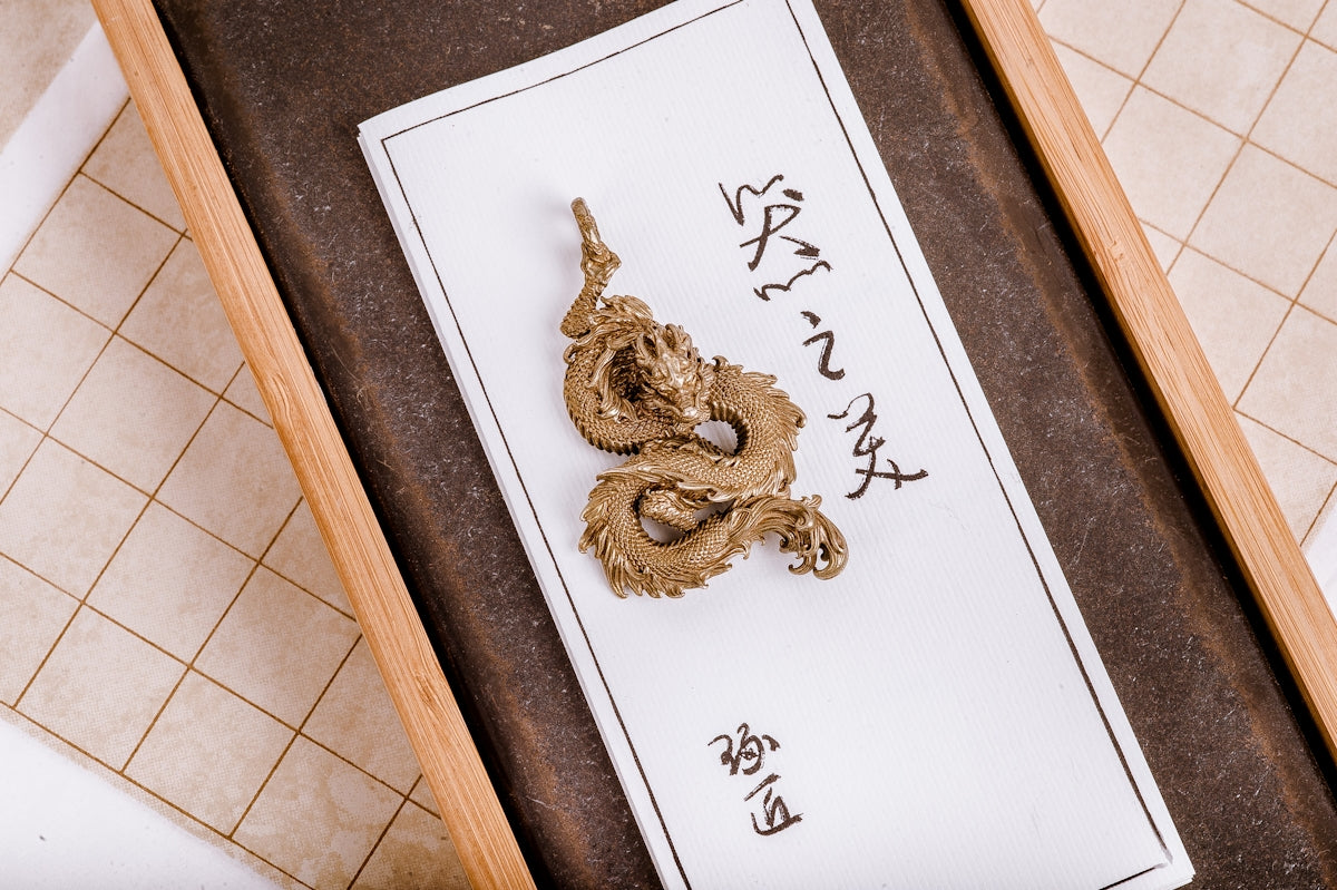 a piece of gold foil sitting on top of a piece of paper