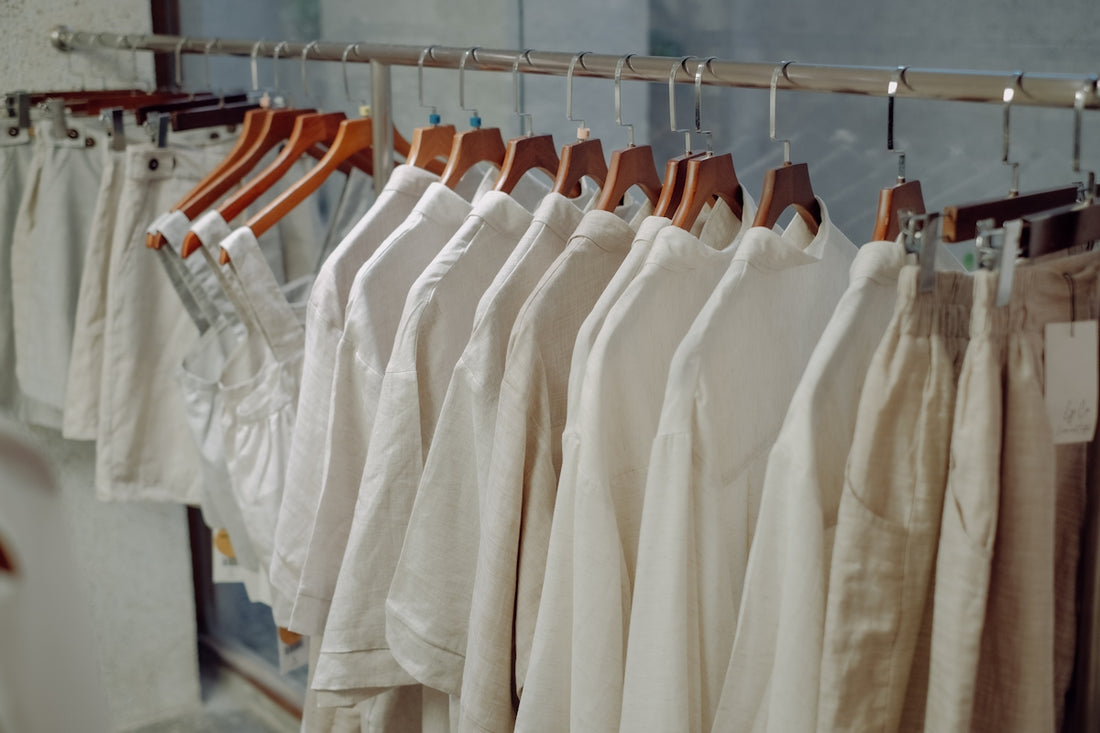 a row of white shirts hanging on a rail