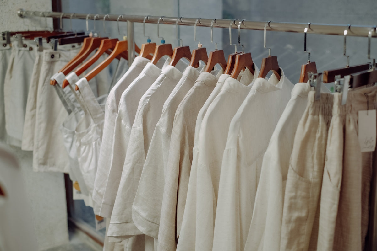 a row of white shirts hanging on a rail