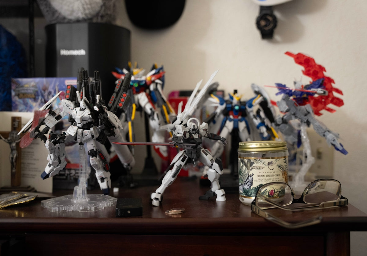 a table topped with toy figurines and a jar of paint