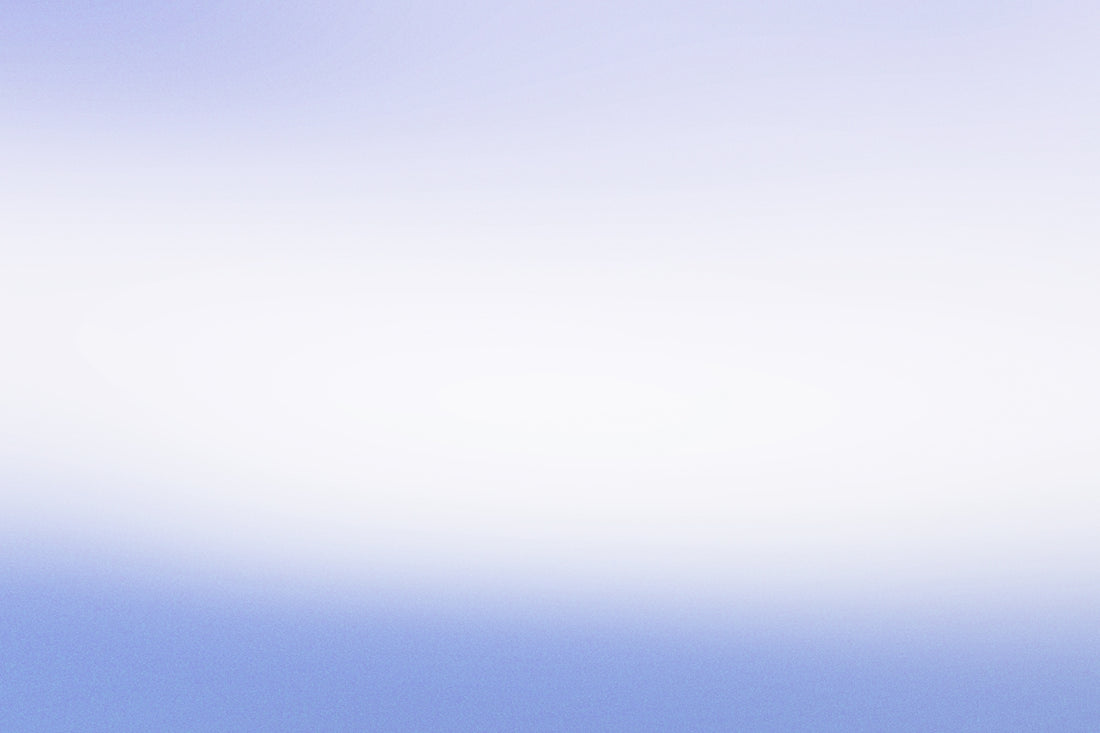 a person flying a kite in a blue sky