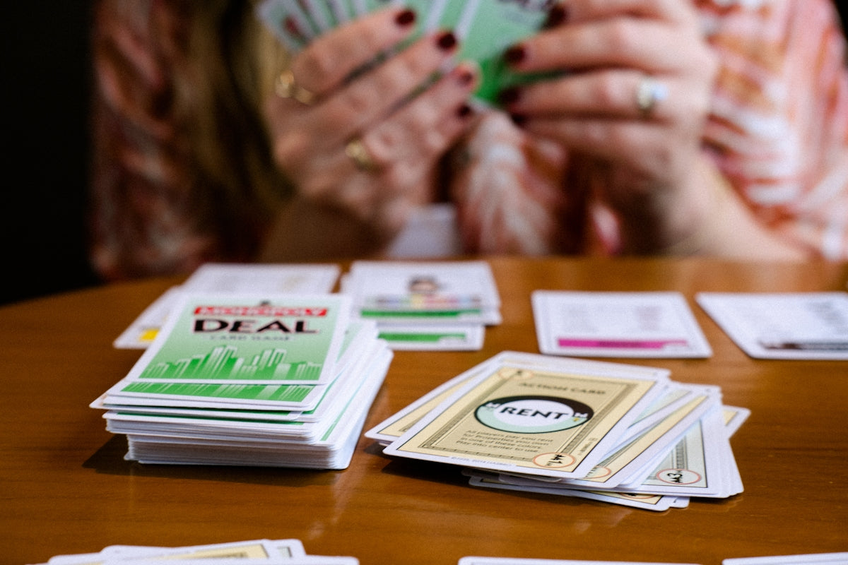 A woman sitting at a table holding a green card