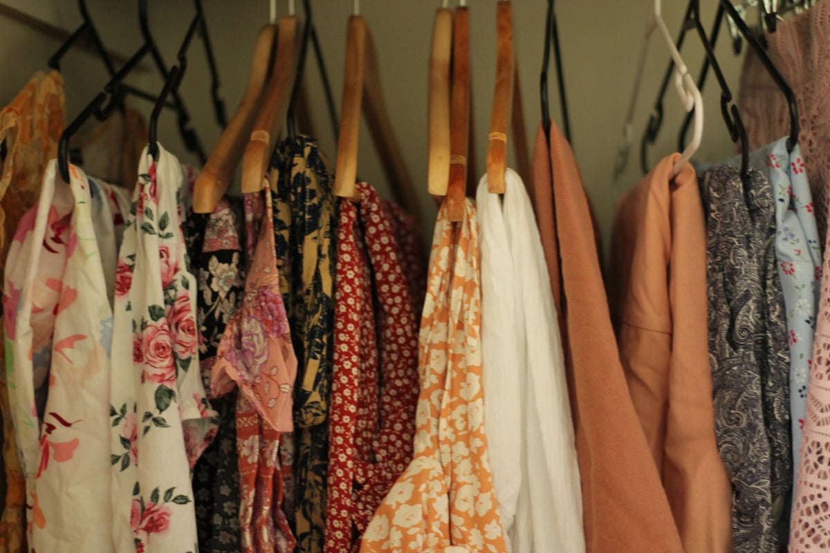 A rack of clothing hanging on a wall