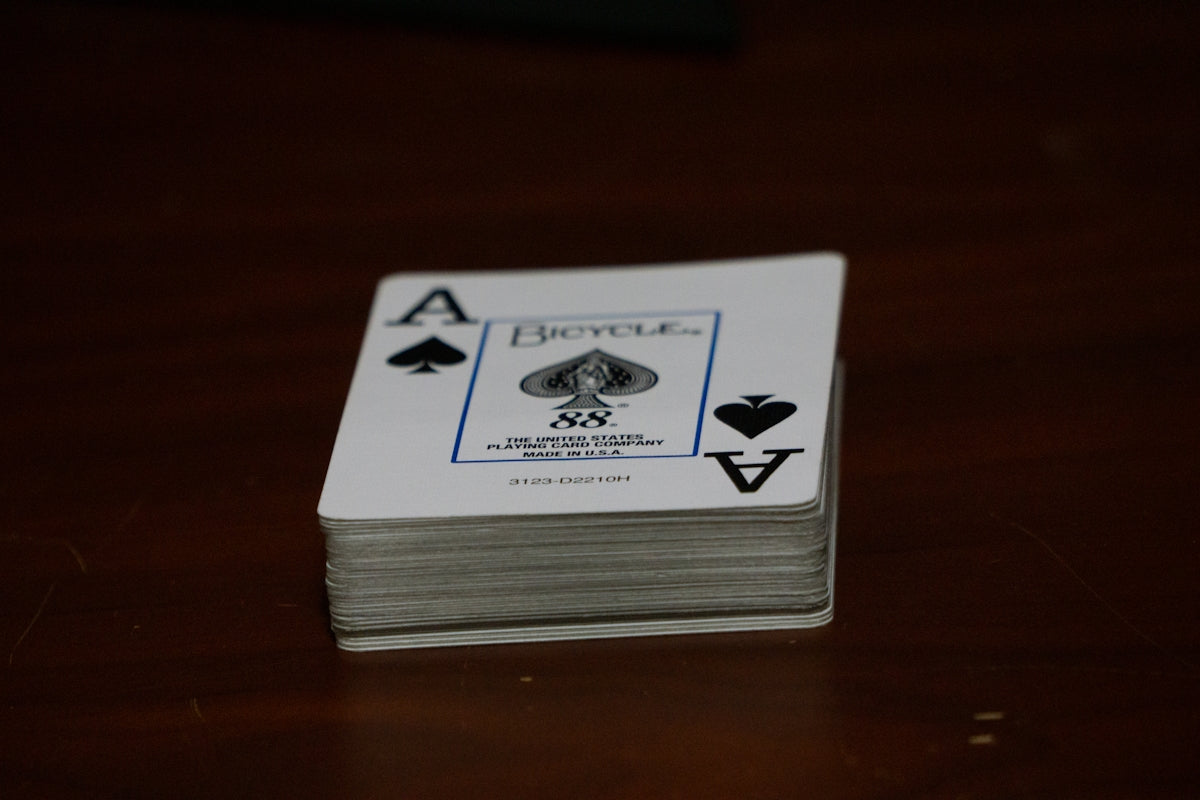 A stack of playing cards sitting on top of a wooden table