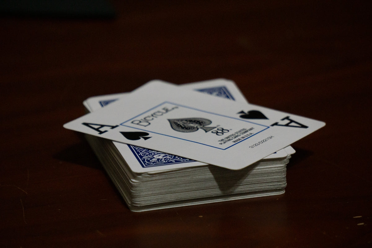 A stack of playing cards sitting on top of a wooden table