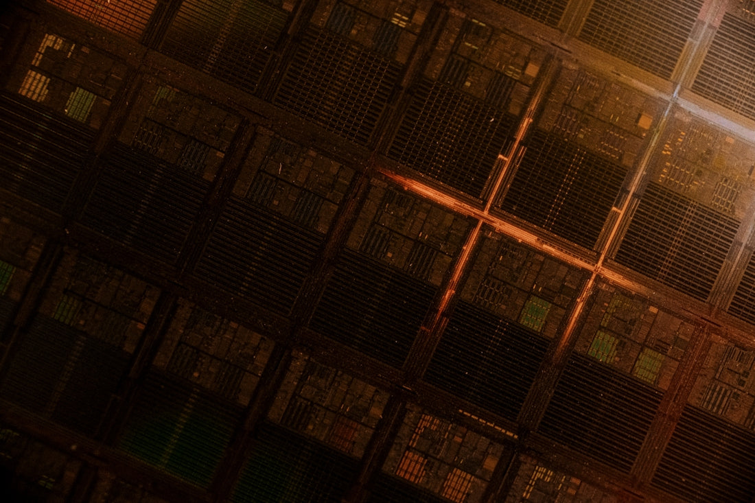 A man standing in front of a large stack of servers