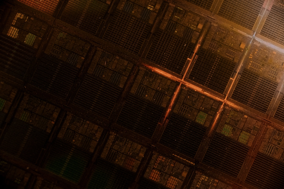A man standing in front of a large stack of servers