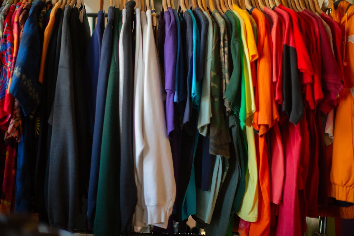 A rack of colorful shirts hanging on a wall