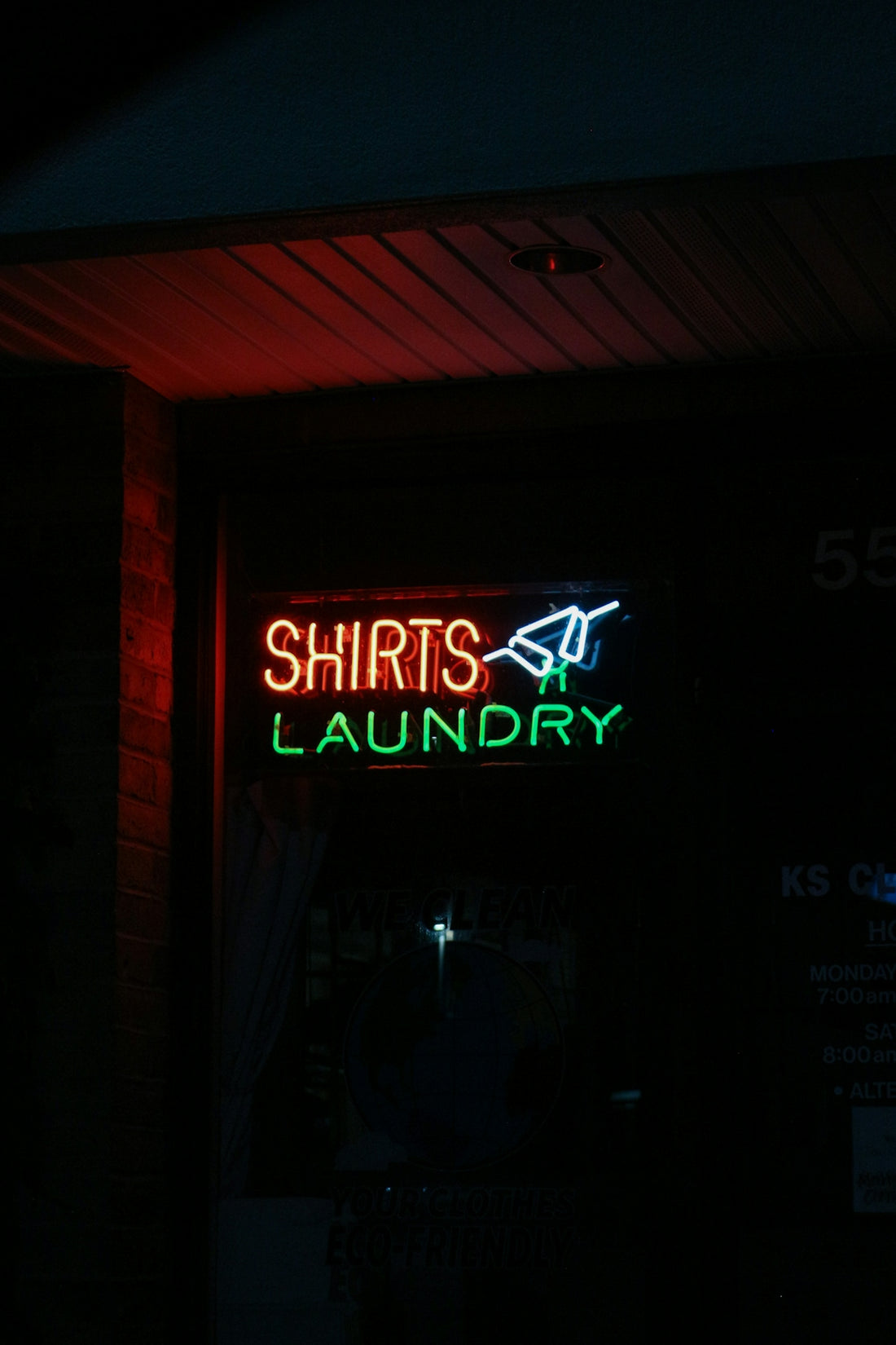 A neon sign that is on the side of a building