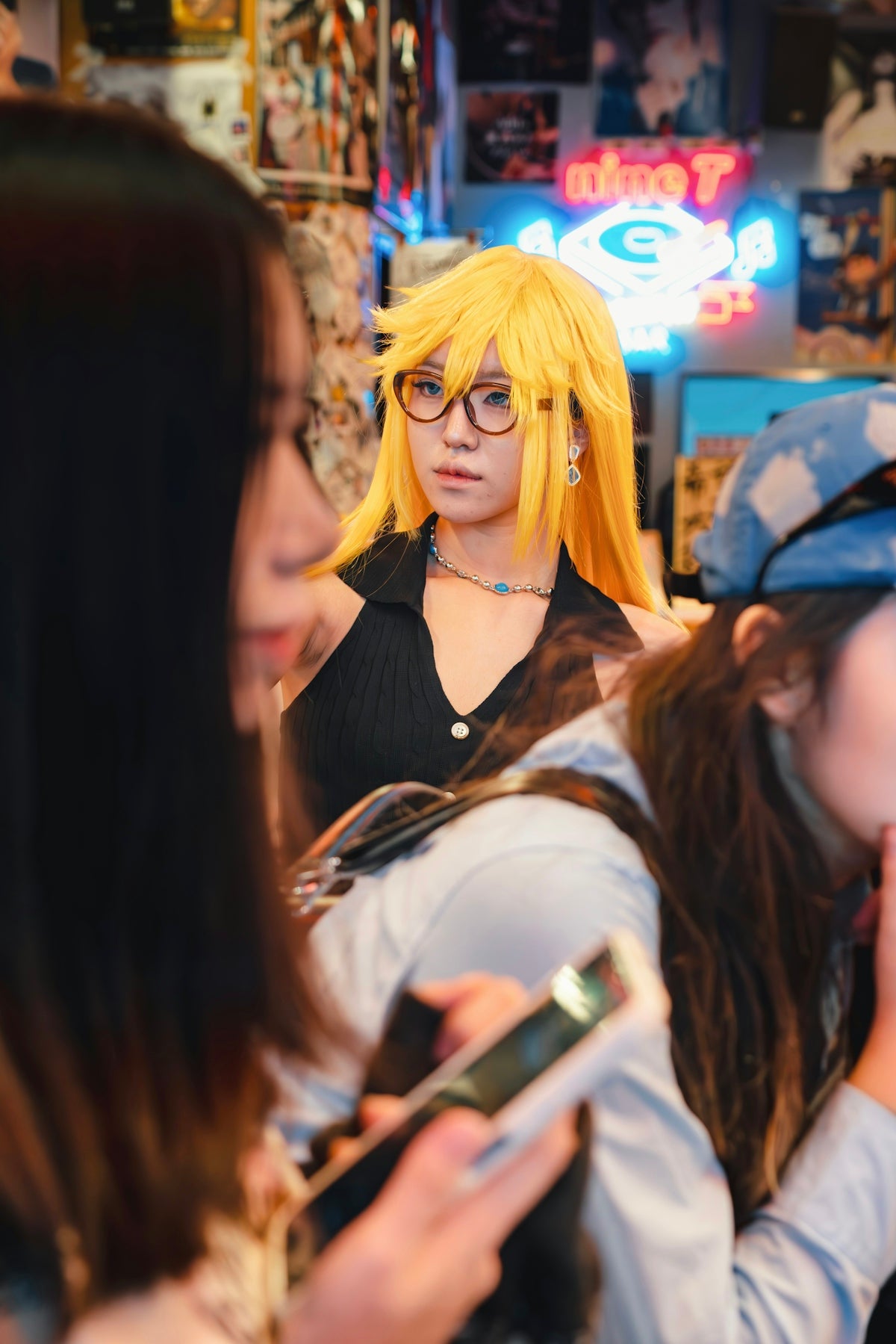 A cosplayer with yellow hair is posing.