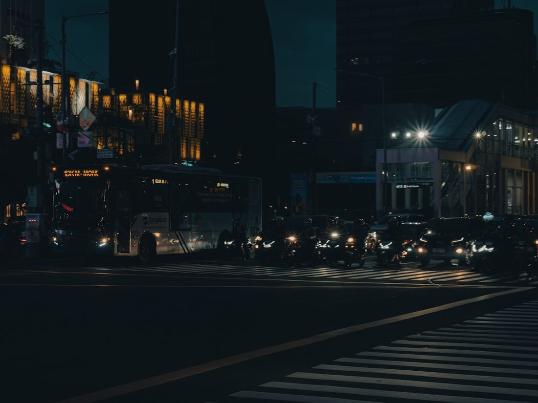 Nighttime traffic on a dark city street.