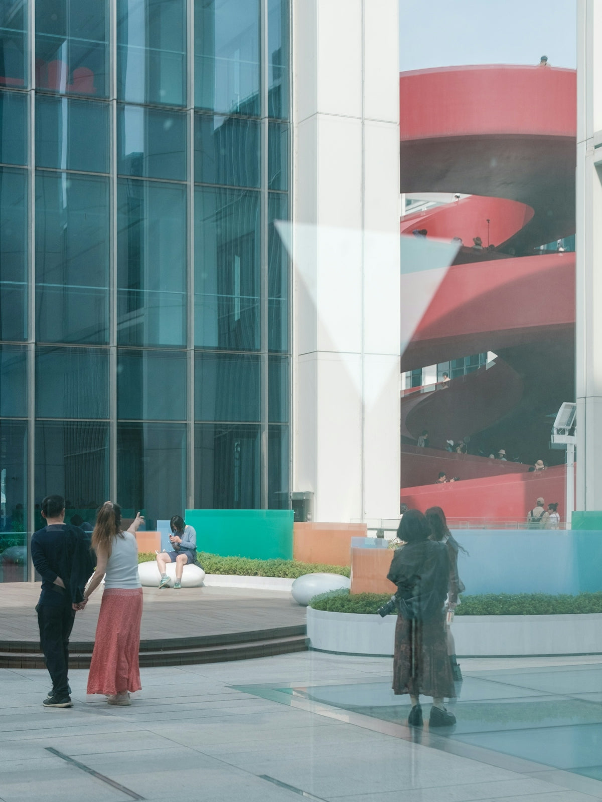 People wander in an outdoor urban space.