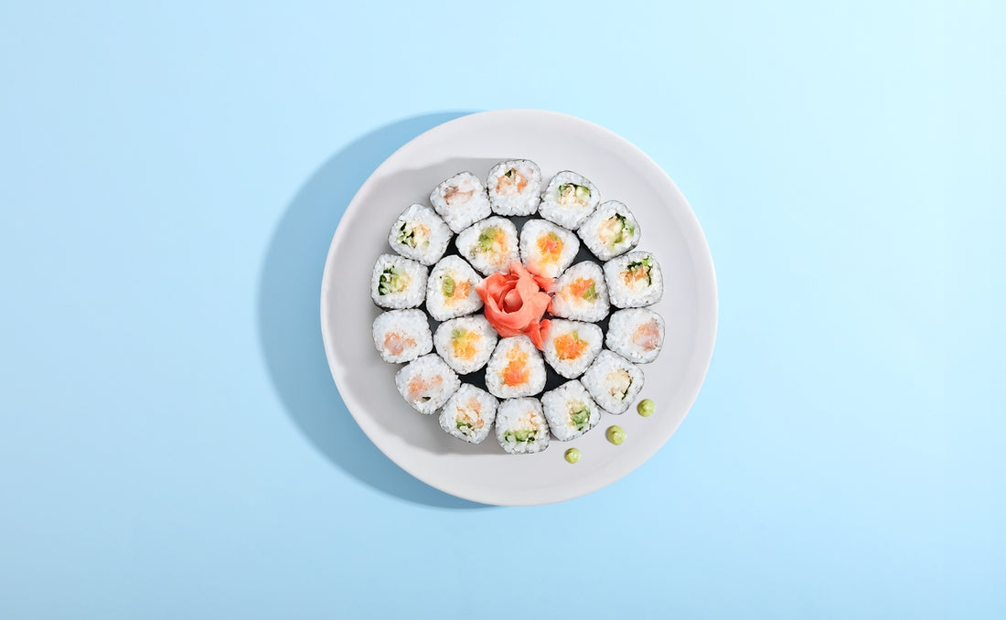 Sushi rolls artfully arranged on a plate.