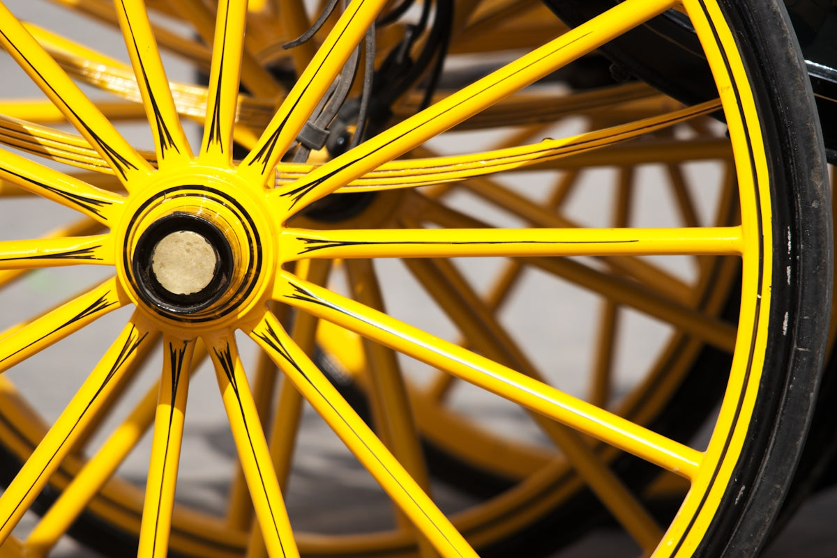 Yellow wheels of an old carriage.
