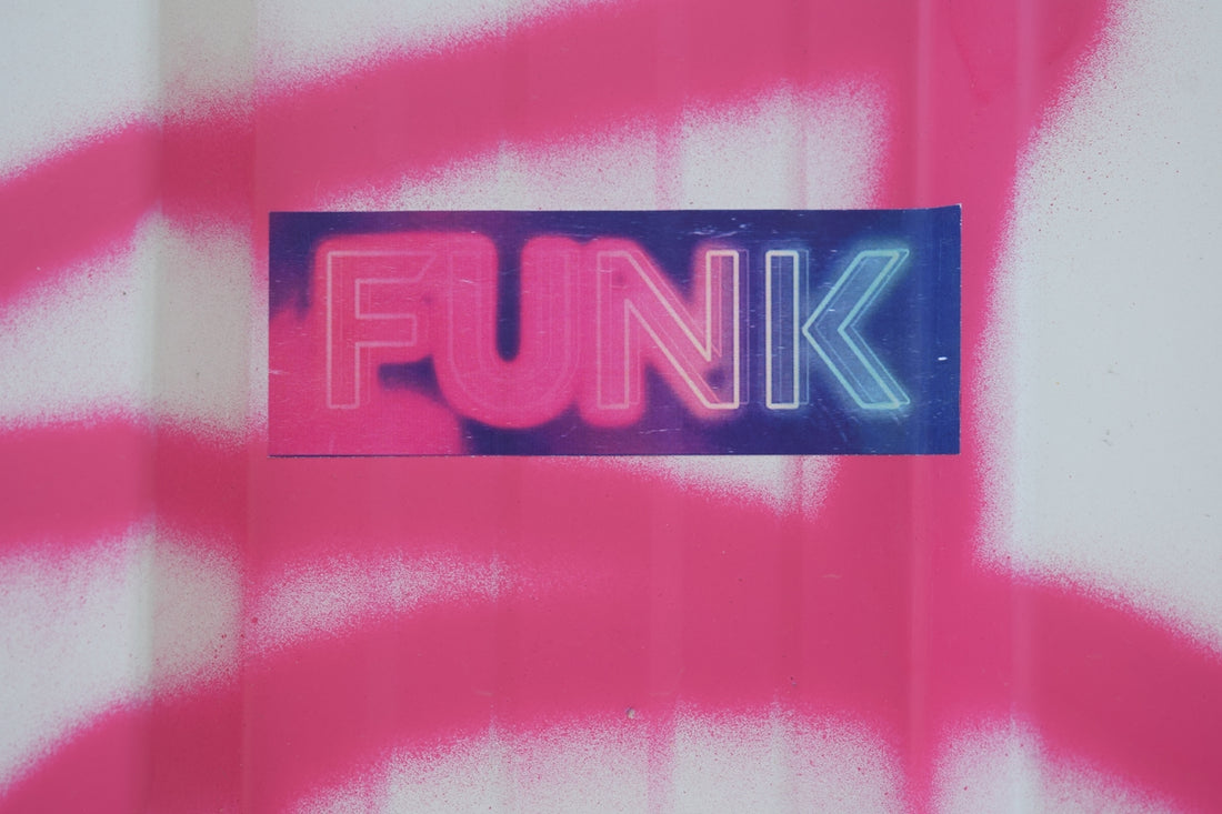 Neon sign with the word funk on a pink background.