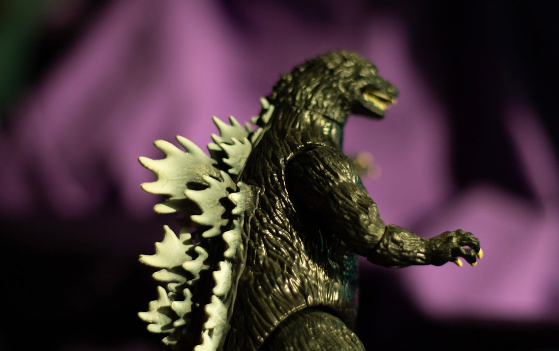 Godzilla toy figure with purple background
