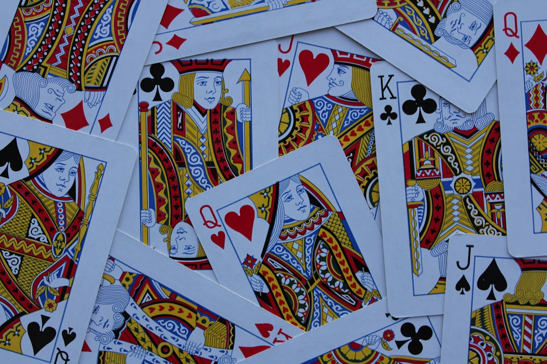 Scattered playing cards with kings, queens, and jacks.